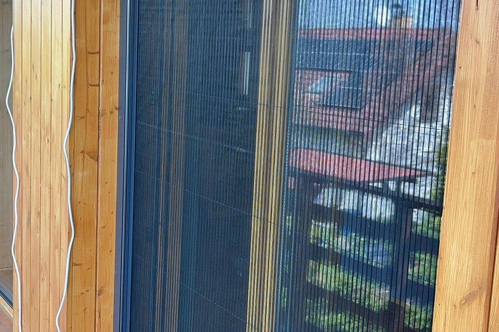 Síť proti hmyzu na dřevěných dveřích