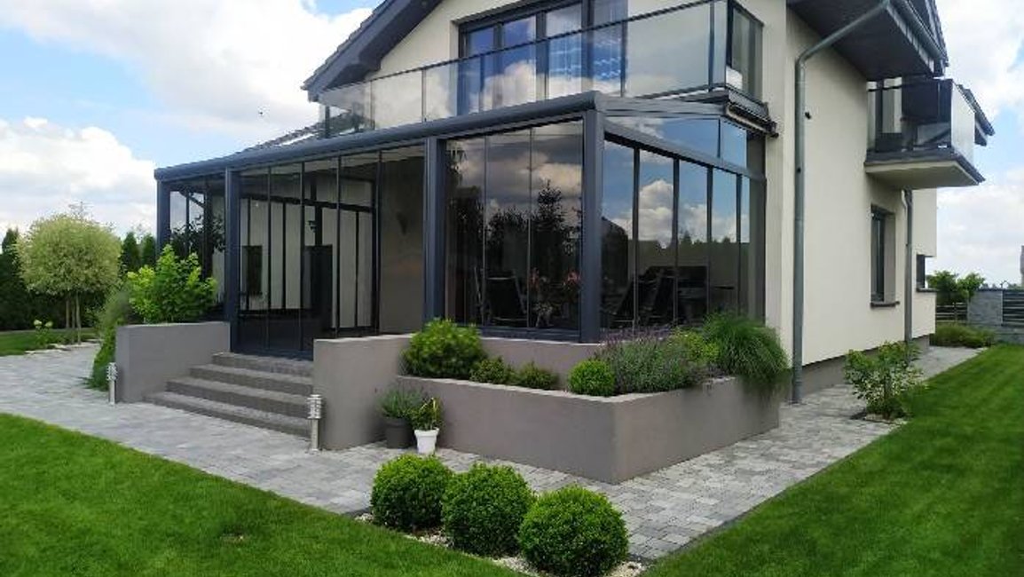 Luxusní zimní zahrada Hezký stín – hliníková konstrukce v barvě RAL 7016, prosklené stěny, elegantní propojení domu se zahradou. Ideální prostor pro relax, posezení i celoroční užívání.