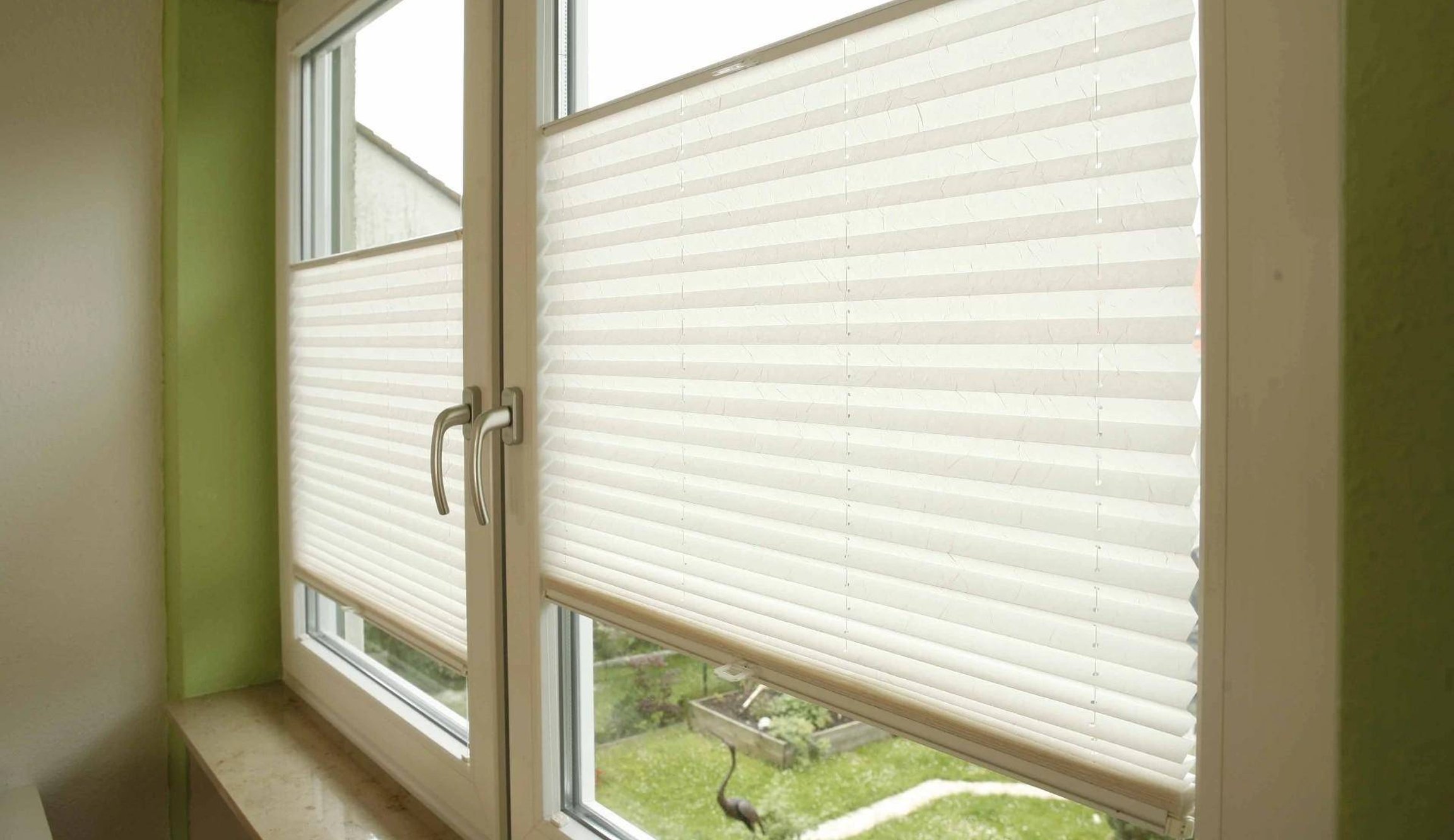 Plisé žaluzie v bílých plastových oknech